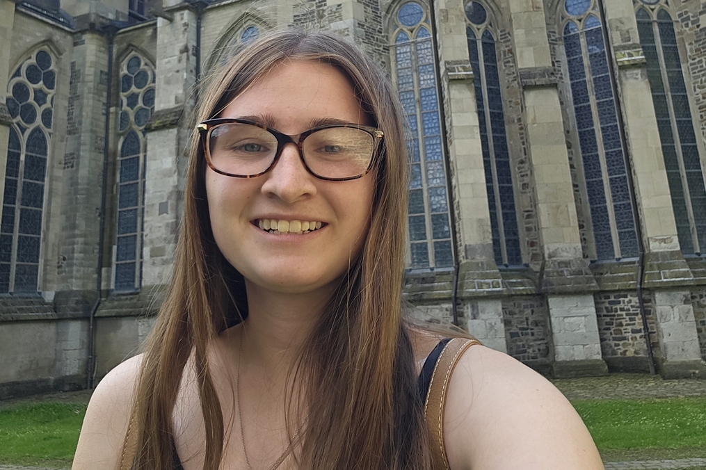 Kaylee Hodges takes selfie in front of cathedral.