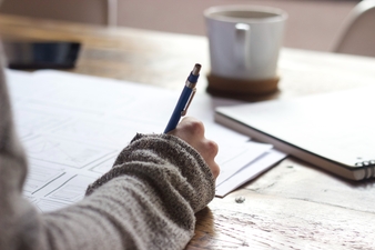 A hand holding a pen taking an exam